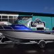 Grey, blue and black boat with soft top black canopy with black mercury motor, on trailer