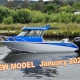 Blue and white boat with black motor, white rails and hard top canopy with white rails